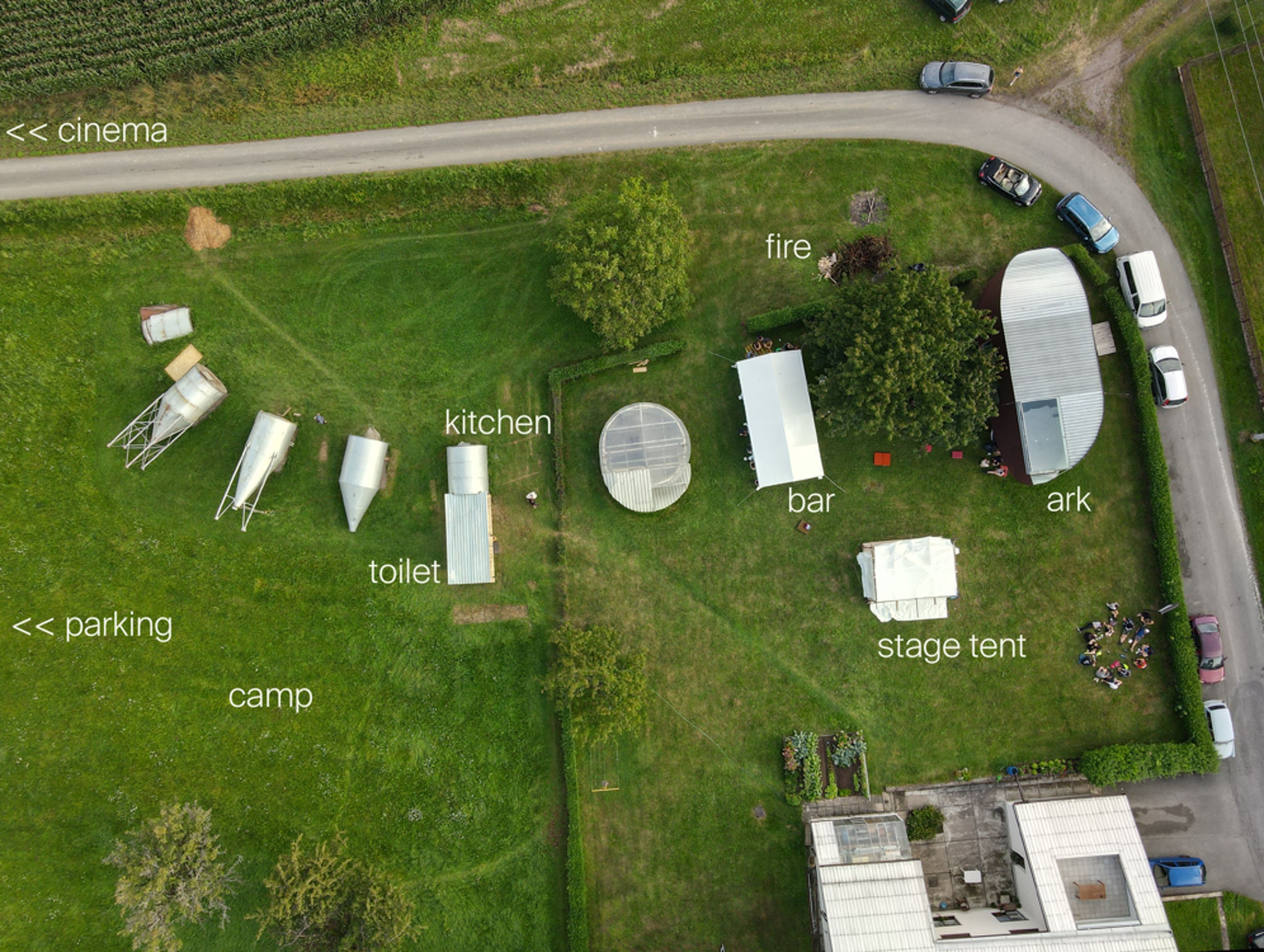 Detailed festival layout with stage tent, kitchen, bar, and camping areas